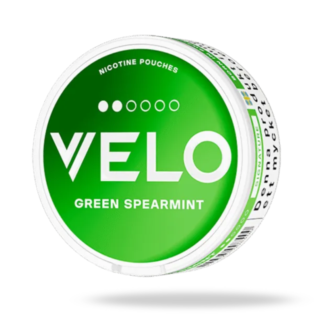 Front-side angled view of a Velo Green Spearmint nicotine pouch can, showing the green label and white slim design. The label highlights its minty spearmint-menthol flavor and 6mg nicotine strength (medium 2‑dot).