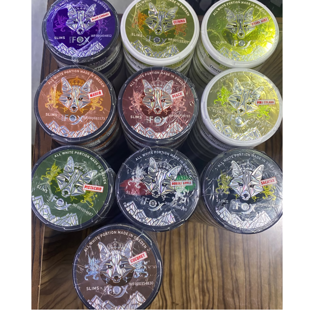 Fox nicotine pouch cans in assorted fruit and mint flavors: Pistachio, Citrika, Peach, Double Apple, Black Currant, Pina Colada, Mango, Coconut, Guava Mint, and Salmiak.